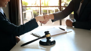attorney and client shaking hands.